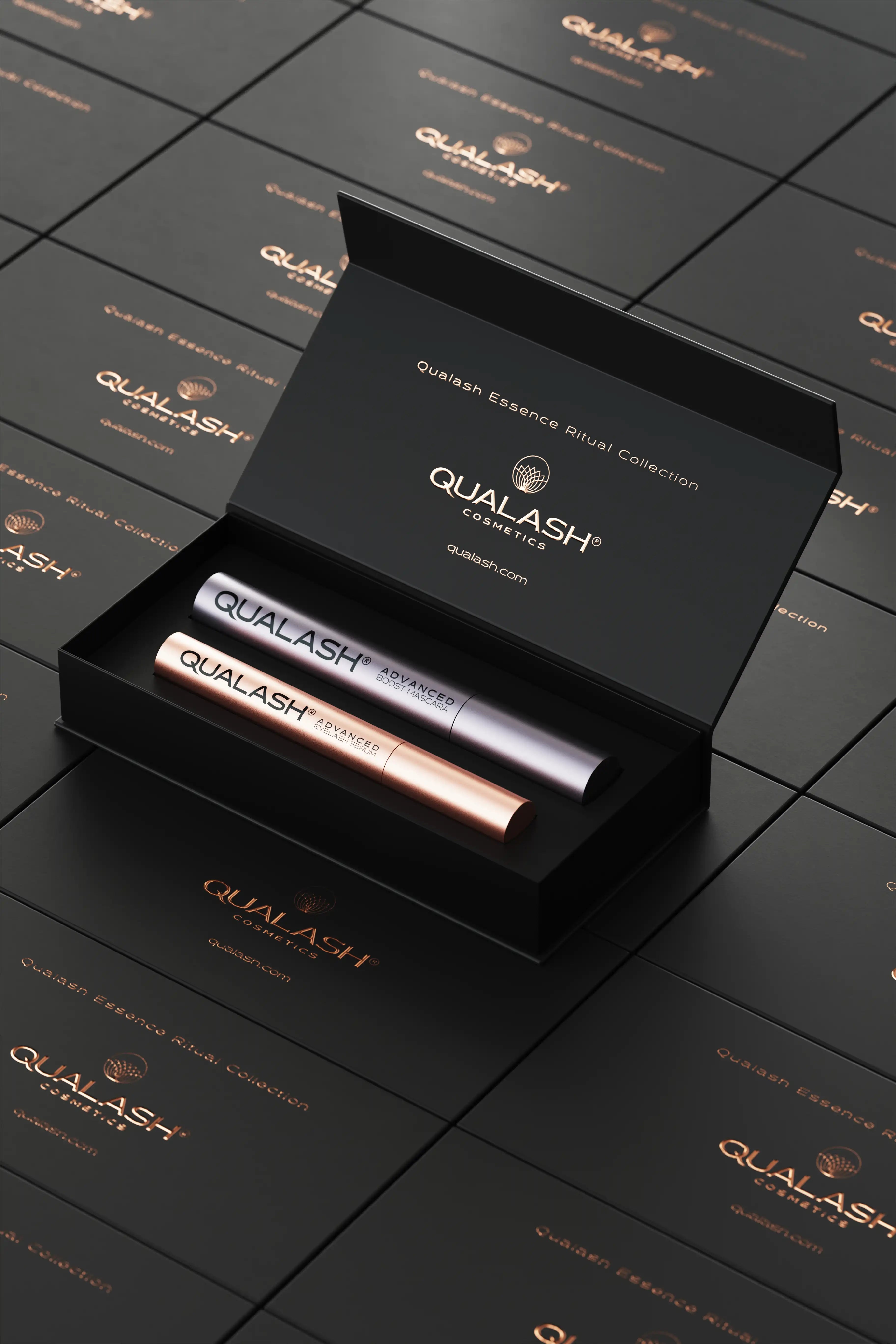 QUALASH Ritual Collection set opened on top of stacked branded gift boxes – elegant top-down perspective.