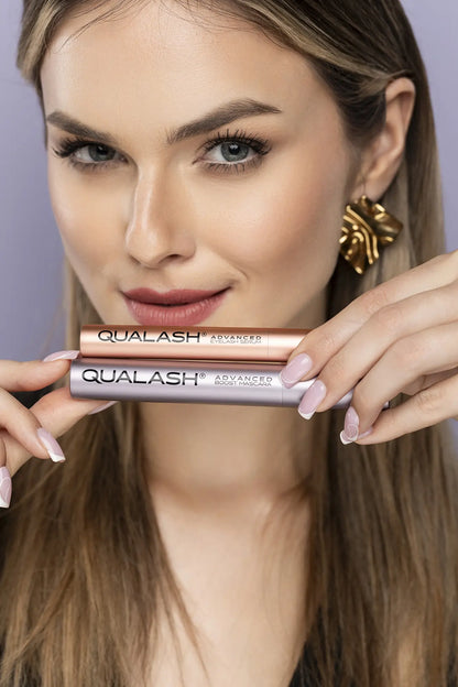 Close-up of hands holding QUALASH Advanced Eyelash Serum and Mascara Volume Max